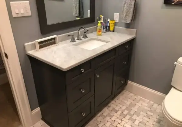 Modern bathroom vanity with marble countertop and mirror.