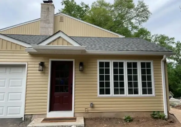 Single-story house with large windows and garage.