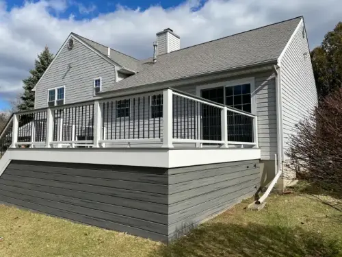 House with elevated wooden deck and railing