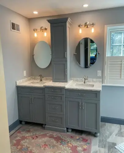 Modern gray double vanity bathroom with mirrors.