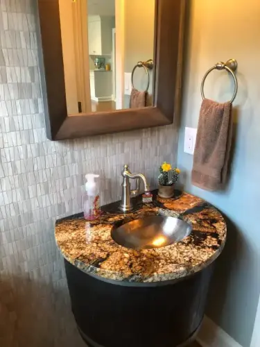 Modern bathroom sink with granite countertop.