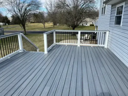 Large gray outdoor deck with white railing
