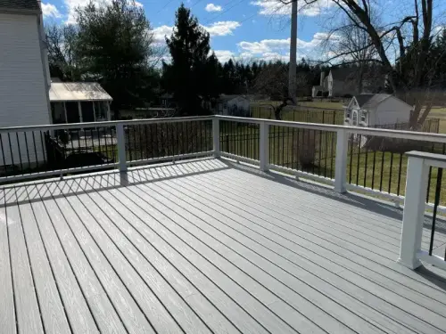 Sunny backyard deck with white railing