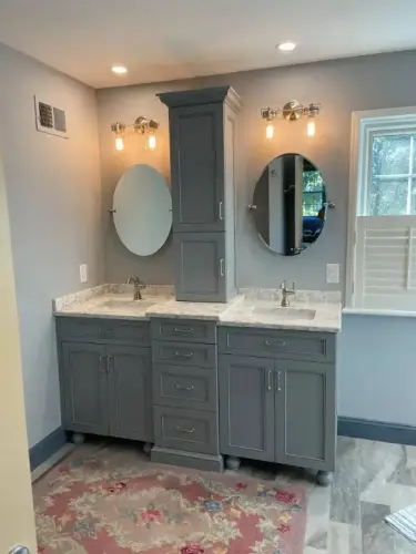 Modern bathroom vanity with dual sinks and mirrors.