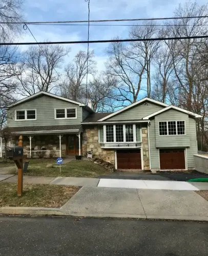 Two-story suburban house with garage and driveway.