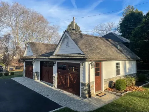 Charming two-car garage with wooden doors