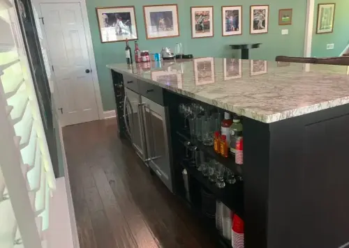 Modern home bar with marble countertop.