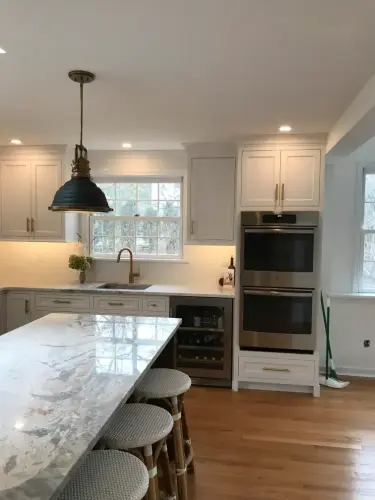 Modern kitchen with marble island and stools