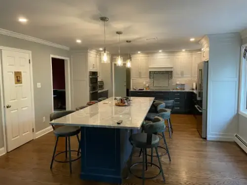 Modern kitchen with large island and bar stools.