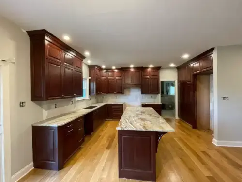 Spacious kitchen with dark wood cabinets and island.