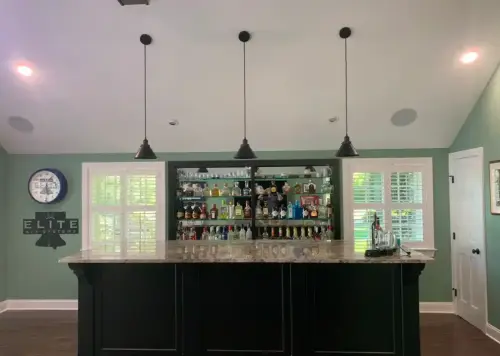 Modern home bar with pendant lighting and shelves