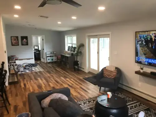 Spacious living room with hardwood floors and TV