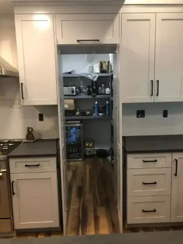 Hidden pantry behind kitchen cabinets.