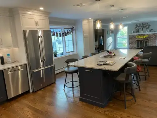 Modern kitchen with island and stainless steel appliances.