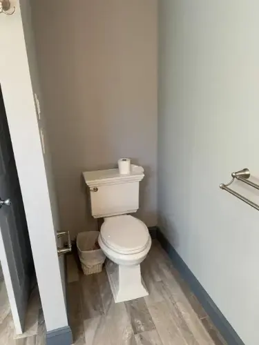 Bathroom with toilet and towel rack.