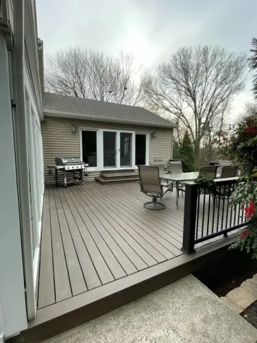 Modern backyard deck with furniture and grill